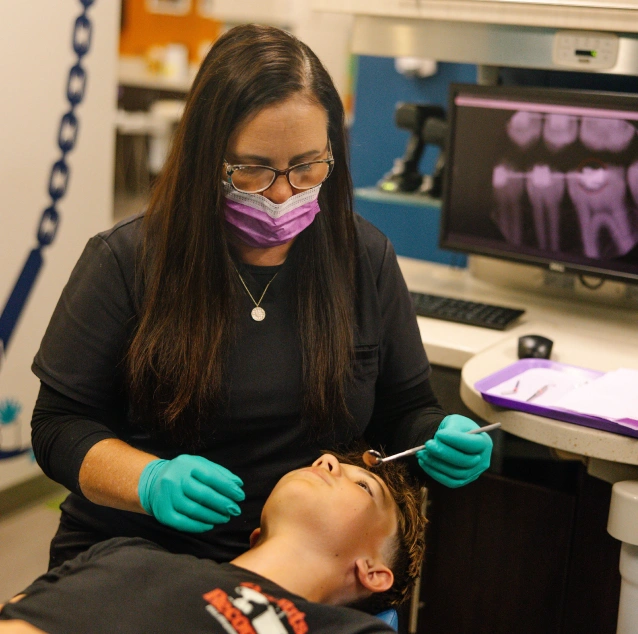Child receiving a comprehensive dental examination at Smile Zone Springfield, MO.