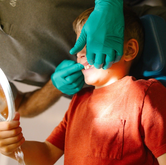 Dental professional checking a child's teeth during a preventive dental visit at Smile Zone Springfield, MO.